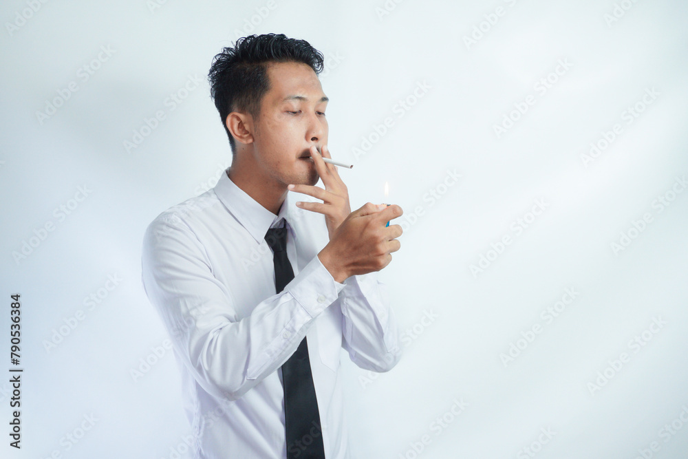 Handsome cool man with Cigarette, going to smoke, isolated on white background, copy space for advertisement. Portrait of asian man in white shirt light cigarette. copy space. Smoking concept Handsome cool man with Cigarette, going to smoke, isolated on white background, copy space for advertisement. Portrait of asian man in white shirt light cigarette. copy space. Smoking concept