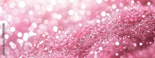 Pink glitter sparkles on a pink background with a blurry background. Banner