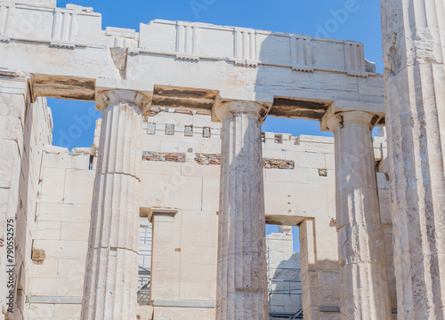 Ancient Greek temple facade with towering columns and stone blocks, in Athens Greece