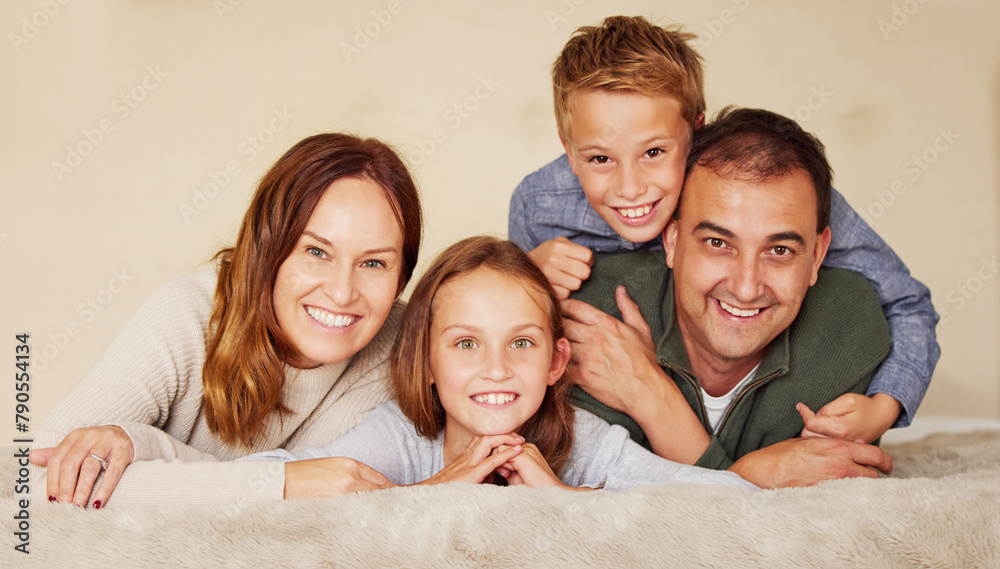 Happy, family and children in portrait on bed to relax, peace and love at home in bedroom. Connection, smile and people in house or apartment for holiday, vacation or together with hug in Spain Happy, family and children in portrait on bed to relax, peace and love at home in bedroom. Connection, smile and people in house or apartment for holiday, vacation or together with hug in Spain