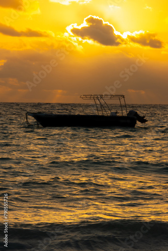 Small boat on the sea at sunrise in Punta Cana © Gilles Rivest