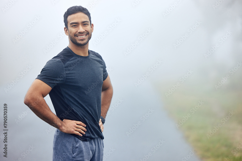 Fototapeta premium Portrait, fog and man outdoor for exercise with runner in nature for cardio, health and wellness. Fitness, workout and run on a misty morning in park, training for marathon or race with confidence