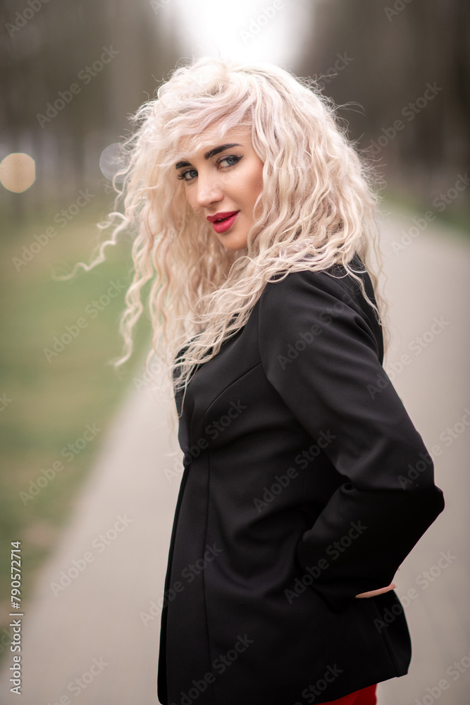 Portrait of a malty beautiful blonde girl on a city street. Portrait of a malty beautiful blonde girl on a city street.