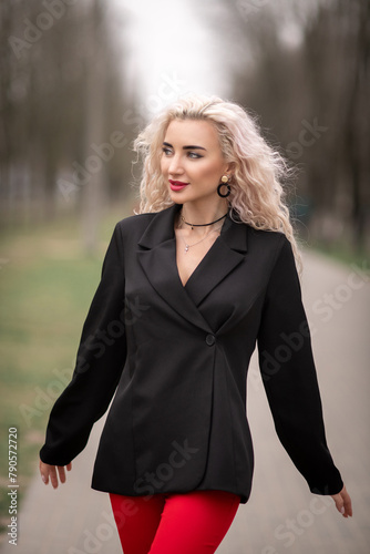 Portrait of a malty beautiful blonde girl on a city street. photo