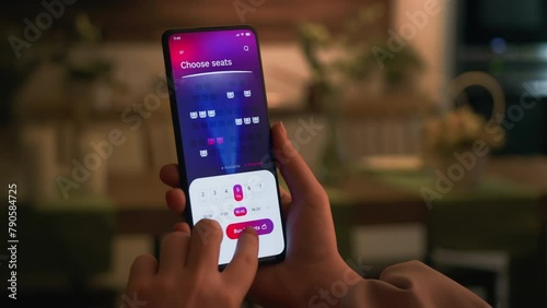 Buying cinema tickets online. Choosing seats in movie theater and buying tickets using app for mobile phone.