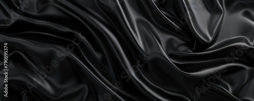 Waves and folds on a black silk satin background. photo