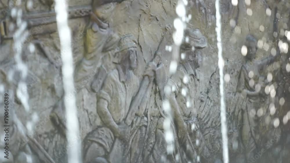 carved statues on the walls near the fountain. close-up view of the fountain near the carved statues carved statues on the walls near the fountain. close-up view of the fountain near the carved statues