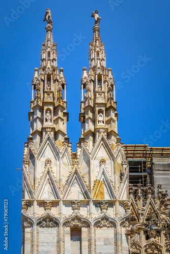 Spires of the Cathedral Duomo di Milano, dedicated to St. Mary of the Nativity. Imposing architectural details close-up. View, details, architectures and embellishments.