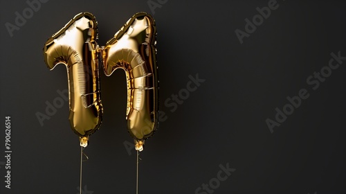 Golden foil balloon number 11 on dark background. Gold birthday decoration