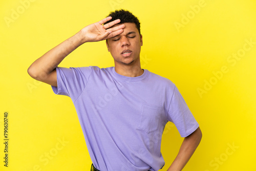 Young African American man isolated on yellow background with tired and sick expression