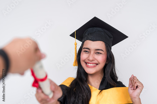 A happy female graduate of bachelor of science proudly receiving her diploma. Beaming with pride and success. Isolated on a white background. photo