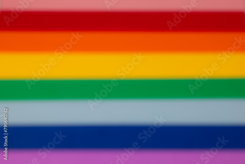 LGBTQ+ gay pride flag is reimagined as a dreamy haze in this image, with the rainbow edges softened into a bokeh blur, symbolizing inclusivity and acceptance