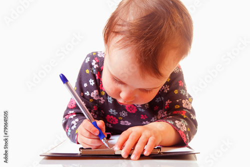 Business concept. Baby girl signs a contract (humorous picture)
