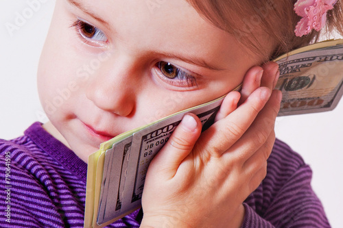 Kids financial literacy concept. Portrait of baby girlwith US Dollar bills.