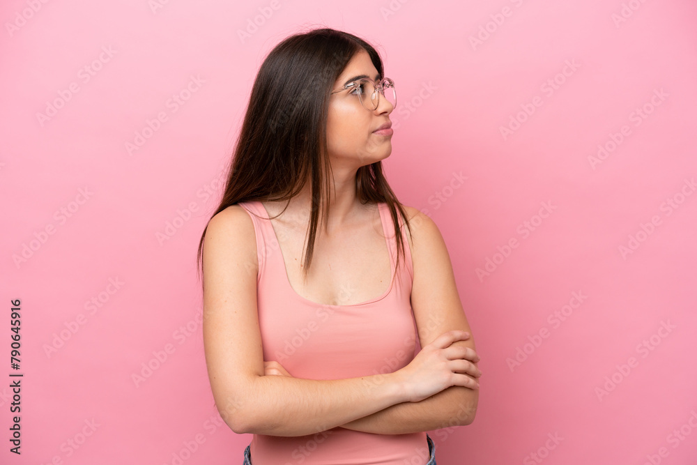 Young caucasian woman isolated on pink background keeping the arms crossed Young caucasian woman isolated on pink background keeping the arms crossed