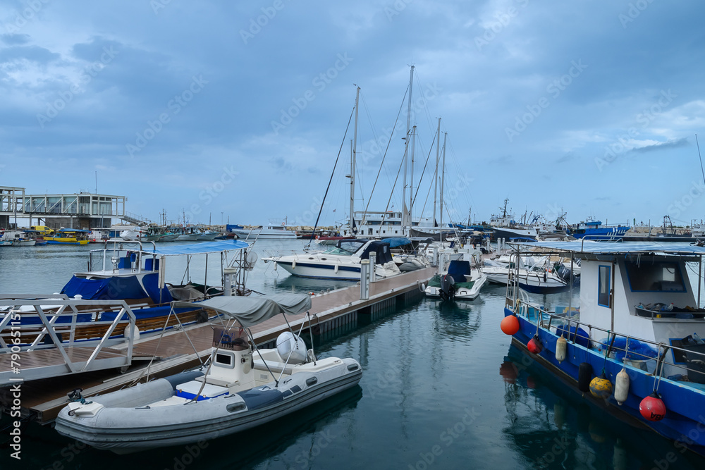 LIMASSOL, CYPRUS - APRIL 15, 2024: Old port of Limassol with beautiful fishing boats at sunset