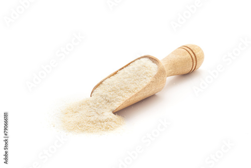 Front view of a wooden scoop filled with Organic Rice Flour (Oryza sativa). Isolated on a white background.
