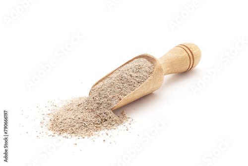 Front view of a wooden scoop filled with Organic Pearl Millet Flour (Pennisetum glaucum)or Bajra Flour. Isolated on a white background.