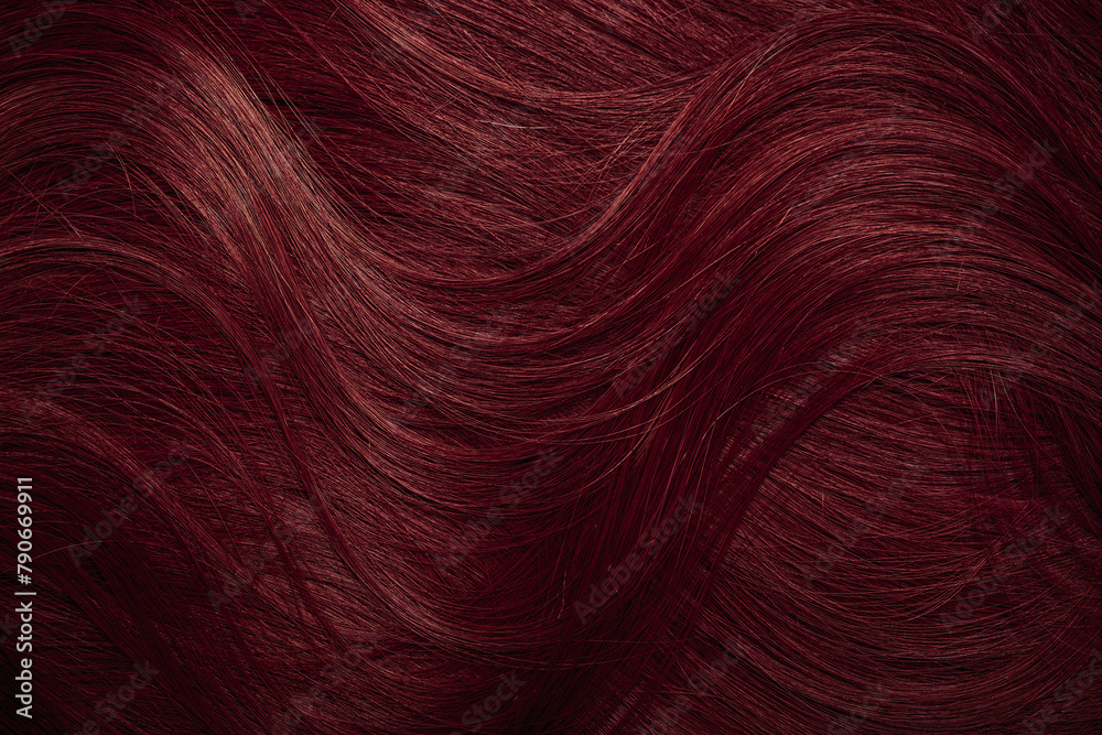 Naklejka premium Dark red hair close-up as a background. Women's long brown hair. Beautifully styled wavy shiny curls. Coloring hair with bright shades. Hairdressing procedures, extension.