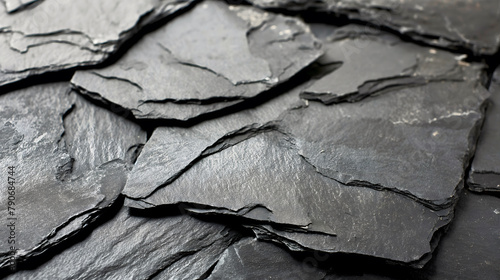High resolution close up of dark slate stone with detailed textures, showcasing the natural layers and rugged surface characteristic of this versatile building material. photo