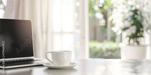 white background with a blurry laptop and a coffee cup on a table