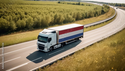 An Netherlands-flagged truck hauls cargo along the highway, embodying the essence of logistics and transportation in the Netherlands