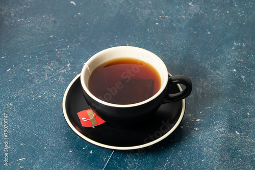 Hot Black Tea with tea bag served on coffee cup isolated on background side view of hot drinkHot Black Tea with tea bag served on coffee cup isolated on background side view of hot drink