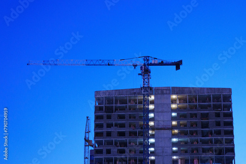 Crane perched on top, ready to lift heavy materials and maid in construction.