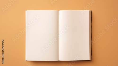 An open hardcover book with blank pages on a tan background photo