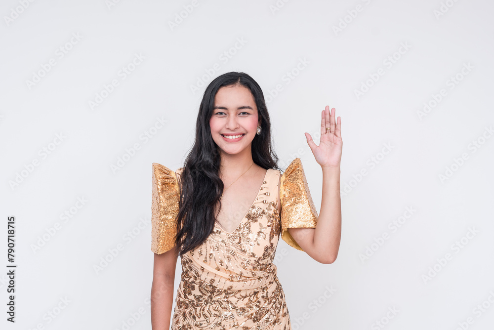 Filipino woman in traditional Filipiniana dress, raising hand on white background Filipino woman in traditional Filipiniana dress, raising hand on white background