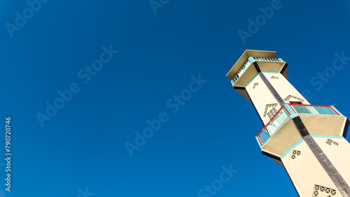 Low angle photo of Indonesian mosque minaret with clear blue sky backgrounds. Empty blank copy text space