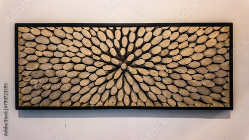 A room wall decoration made from many pieces of wood and arranged in one large frame.