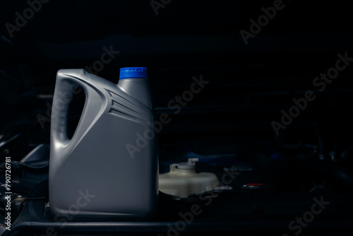 lubricant bottle On the background of engine lubricant, oil change shop, engine service industry. © WIROT