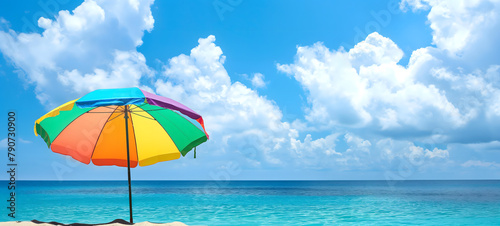 Serene Beach Day with Vibrant Orange and Red Parasol under Sunny Blue Skies