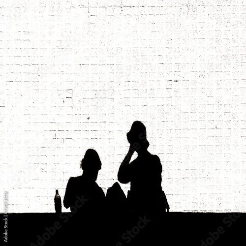 silhouette of a couple sitting on a bench