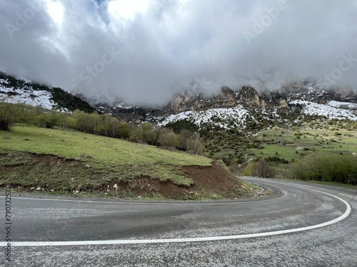 Tseylomsky pass in Ingushetia. A trip uphill to the Tsei Loam pass on a cloudy spring day. Panorama of the high cliffs of the Dzheyrakh gorge. North Caucasus, Russia photo