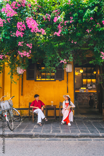 Asian Couple wearing vietnam  traditional culture  walking around at Hoi An ancient town,Hoi an city in Vietnam.