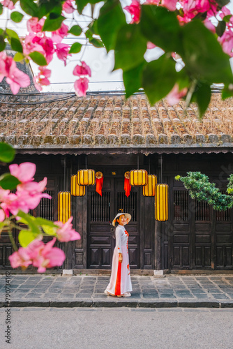 Asian woman wearing vietnam  traditional culture  walking around at Hoi An ancient town,Hoi an city in Vietnam.