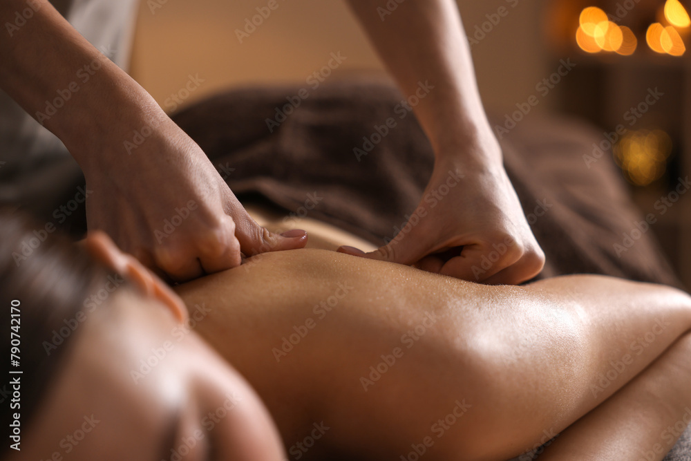 Obraz premium Spa therapy. Beautiful young woman lying on table during massage in salon, closeup