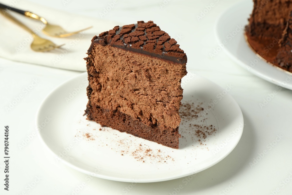 Piece of delicious chocolate truffle cake on white table, closeup Piece of delicious chocolate truffle cake on white table, closeup