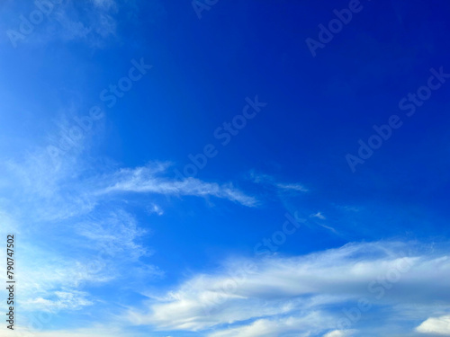 Blue with white background. Aesthetic neutral photo of the sky with small clouds  in sunny weather.