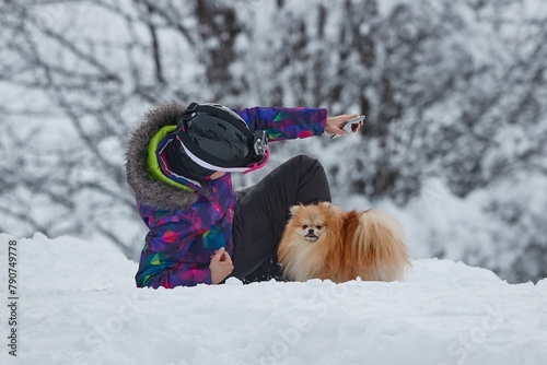 Playing with small dog in the snow photo