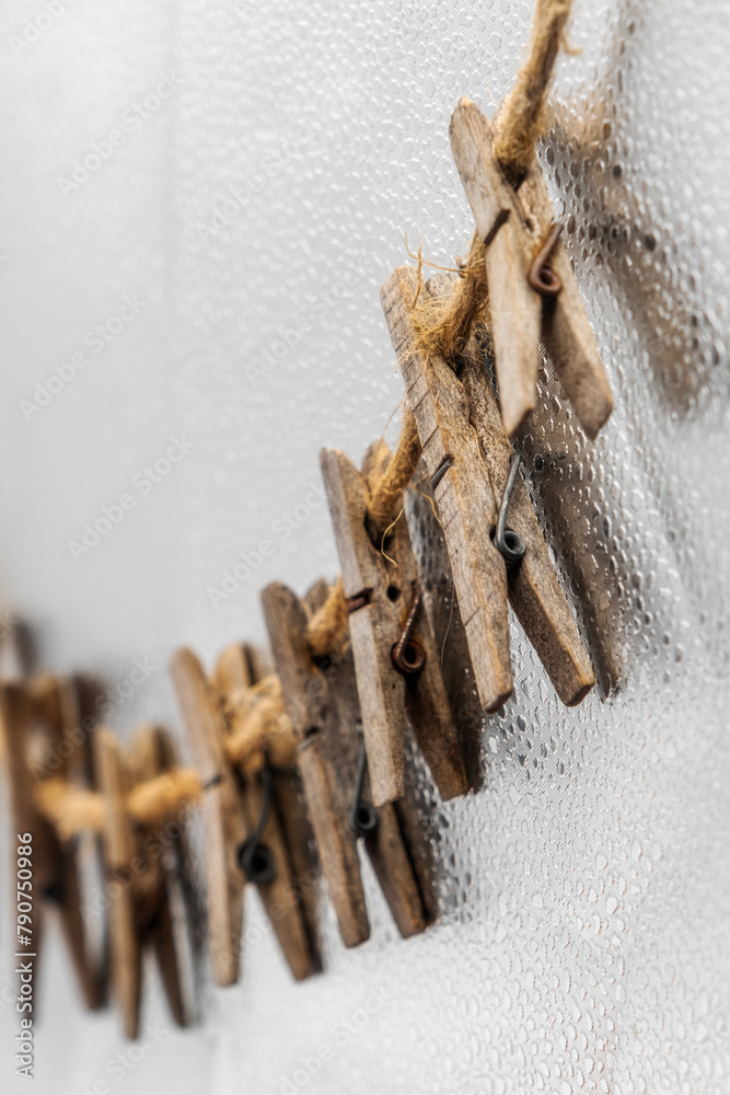 Old wooden clothespins, laundry hooks, on hemp rope Old wooden clothespins, laundry hooks, on hemp rope