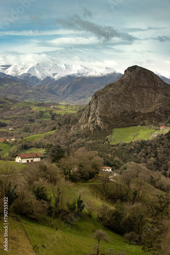VIEW OF MOUNTAINS WITH SNOW-COVERED SUMMITS IN WINTER OF PICOS DE EUROPA FROM LA SALGAR IN ASTURIAS photo