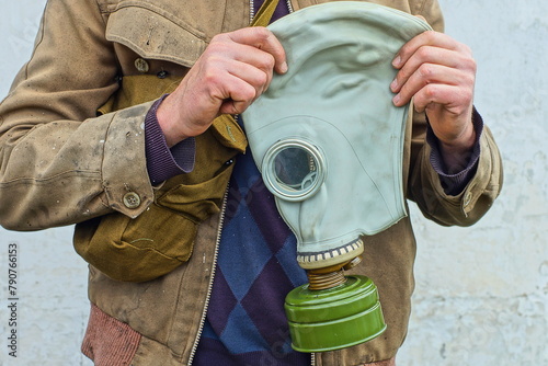 Obraz na plátně one military gray rubber protective gas mask with a green iron filter in the han