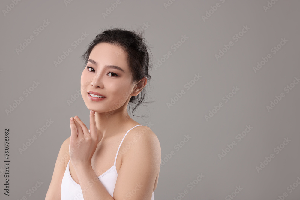Portrait of beautiful woman on grey background, space for text Portrait of beautiful woman on grey background, space for text