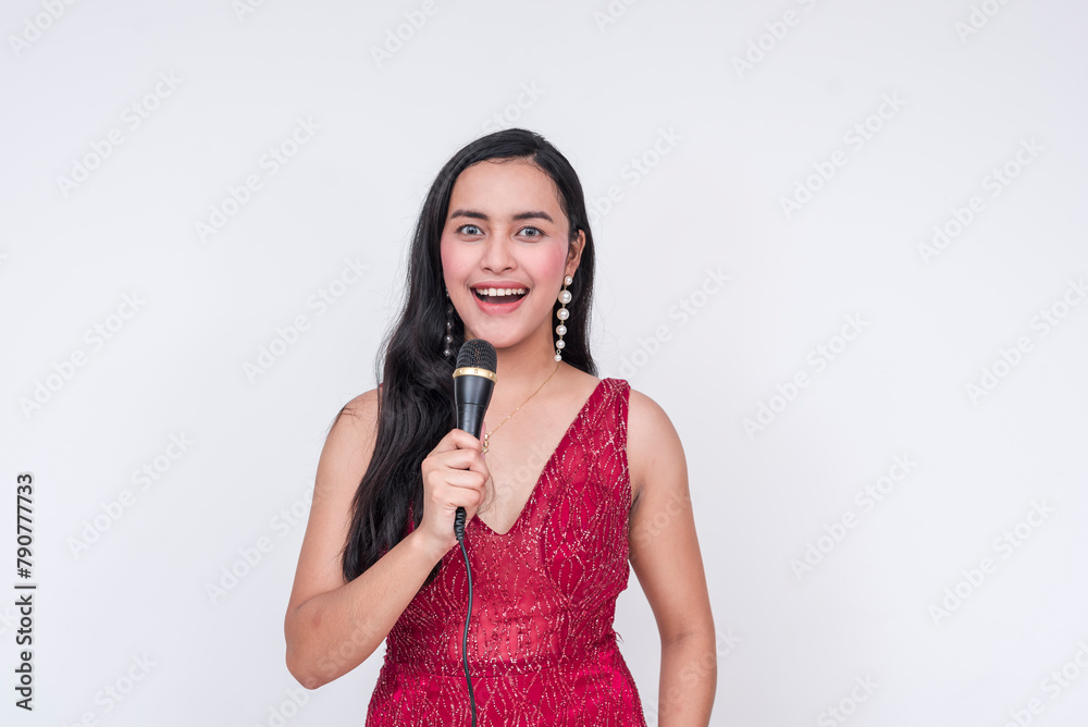 Elated Southeast Asian woman in red gown hosting gala event, isolated on white Elated Southeast Asian woman in red gown hosting gala event, isolated on white