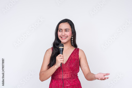 Southeast Asian woman in red gown hosting an event, isolated on white