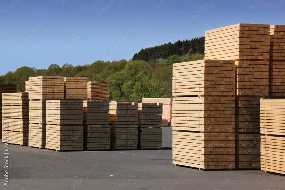 Stacks of squared timber beams stored at a sawmill in Germany