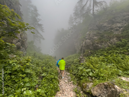 Hiker along the Saugasse path during a foggy day 